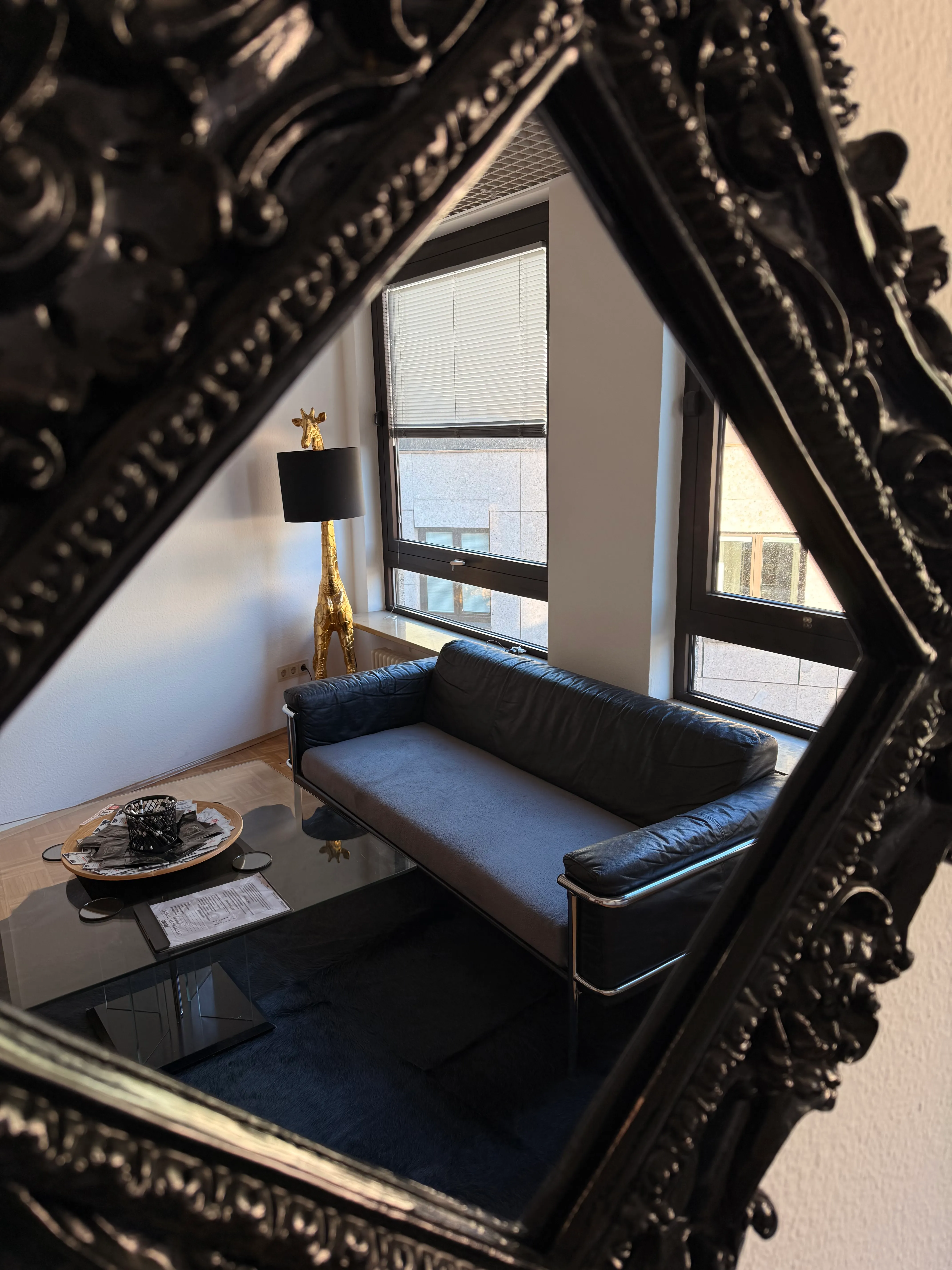 Ornate baroque mirror in the VIP area with stylish lounge furnishings