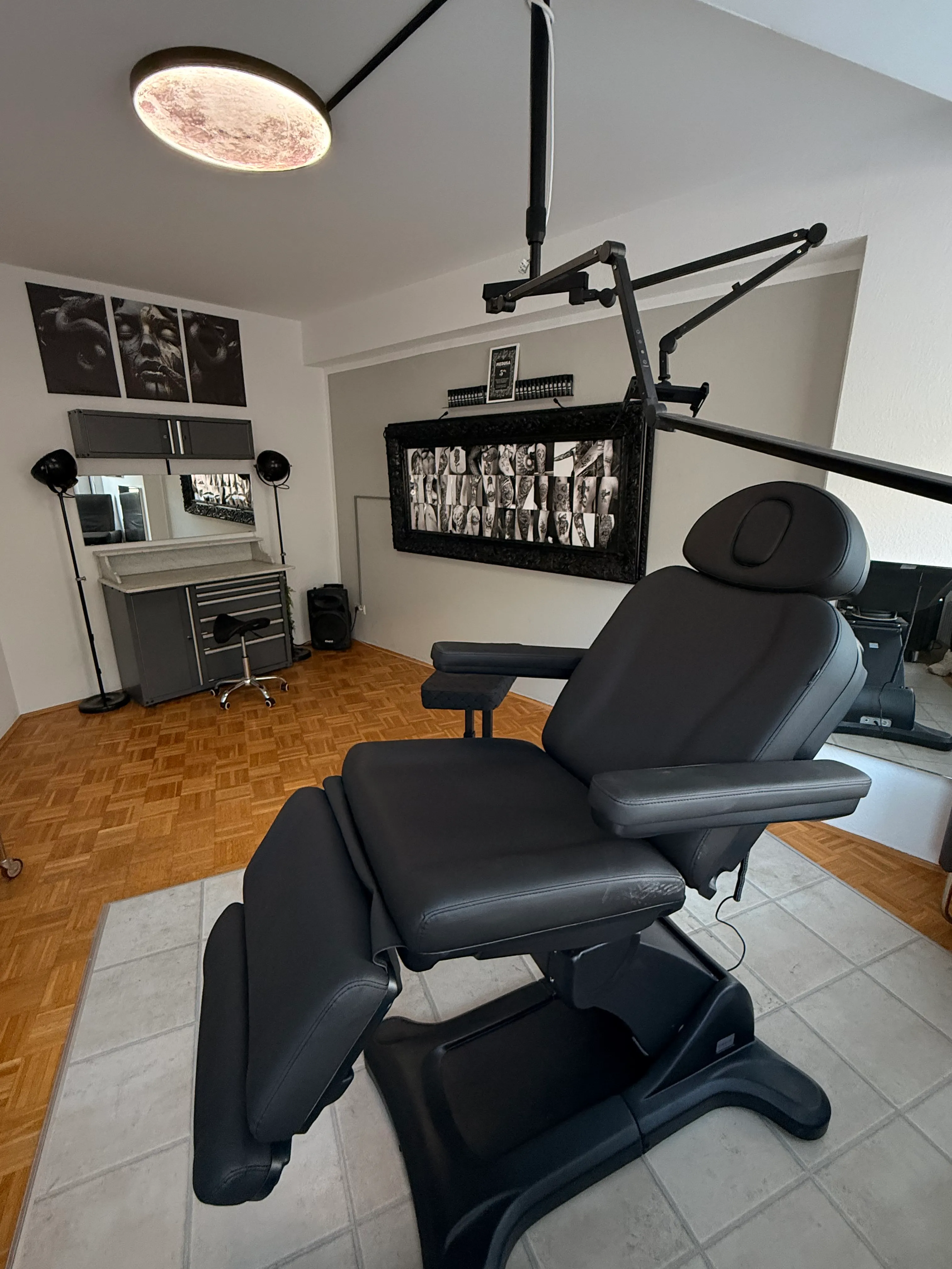 Tattoo workstation in the VIP room with professional equipment and wall art