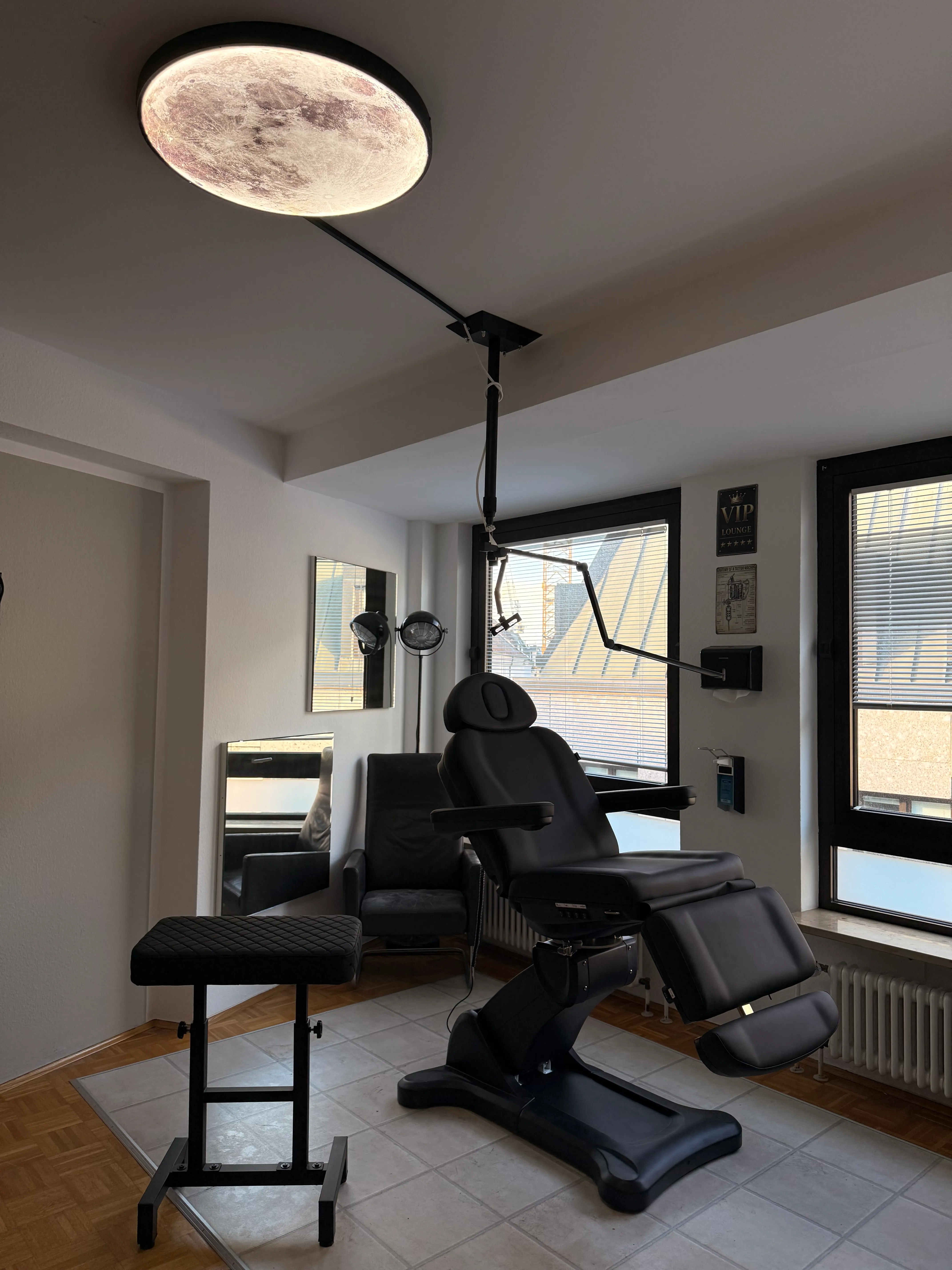 VIP treatment room with tattoo chair and a view over the rooftops of Munich